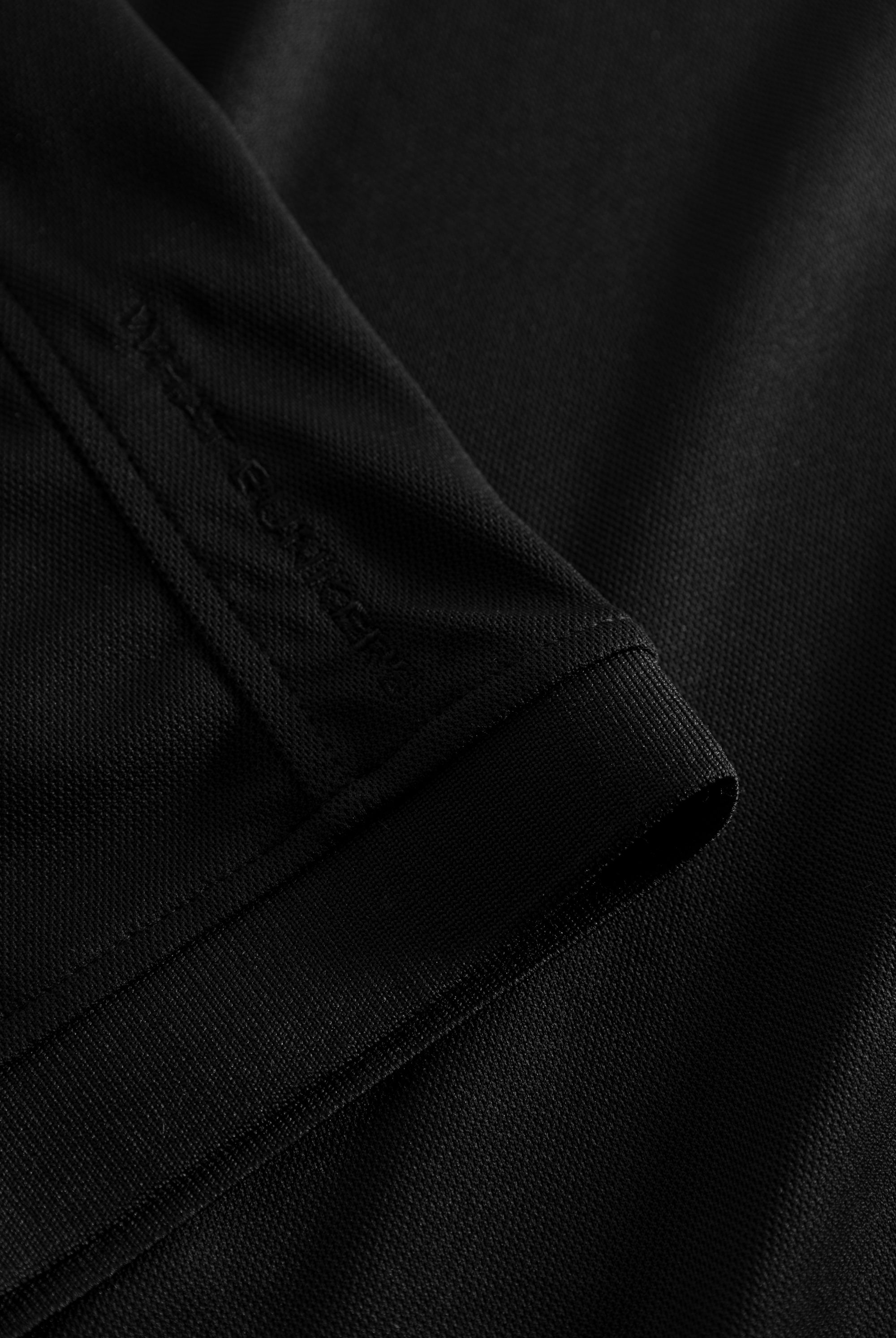 Black golf polo shirt with WHAT BUNKERS details.